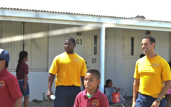 Two ESL Sailors join in a volleyball game at a local Guam school