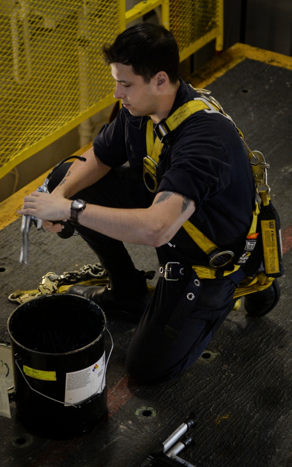 Sailor Cleans Caulking Gun