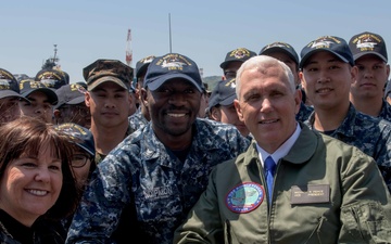Vice President Michael R. Pence and Second Lady Karen Pence, Pose for a Photograph with Service Members on the Flight Deck of USS Ronald Reagan (CVN 76)