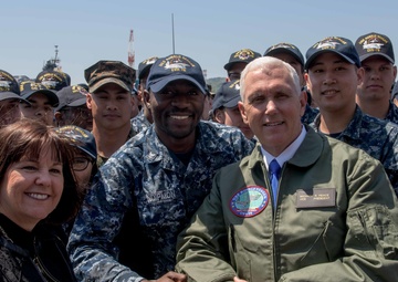 Vice President Michael R. Pence and Second Lady Karen Pence, Pose for a Photograph with Service Members on the Flight Deck of USS Ronald Reagan (CVN 76)