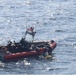 Coast Guard boat crew untangles sea turtles from fishing net