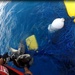Coast Guard boat crew untangles sea turtles from fishing net