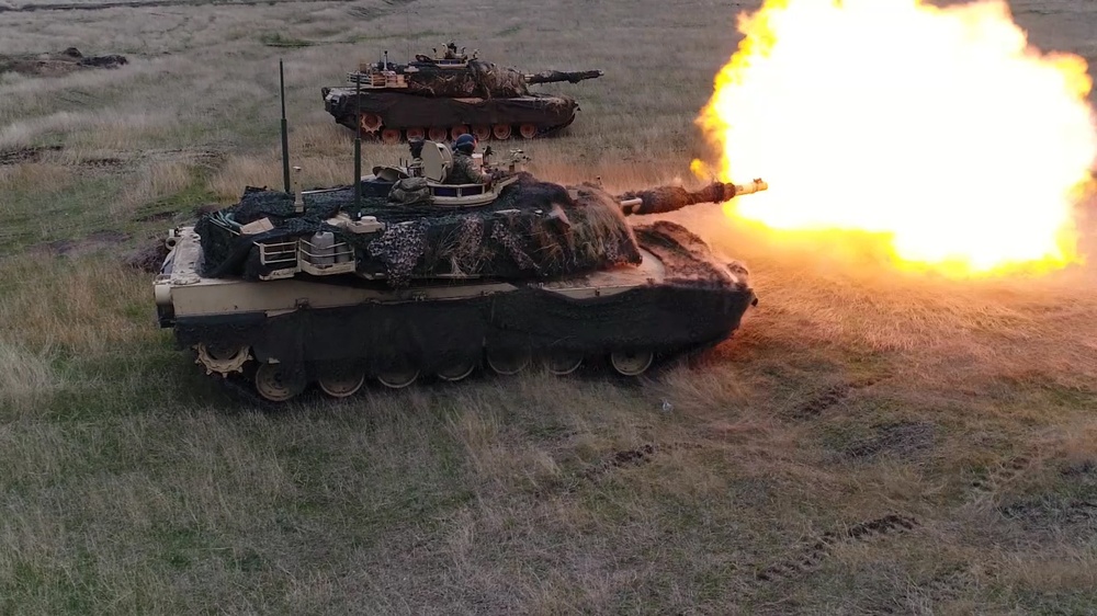 An M1A3 Abrams tank fires a round during a live fire training exercise at Smardan Training Area, Romania