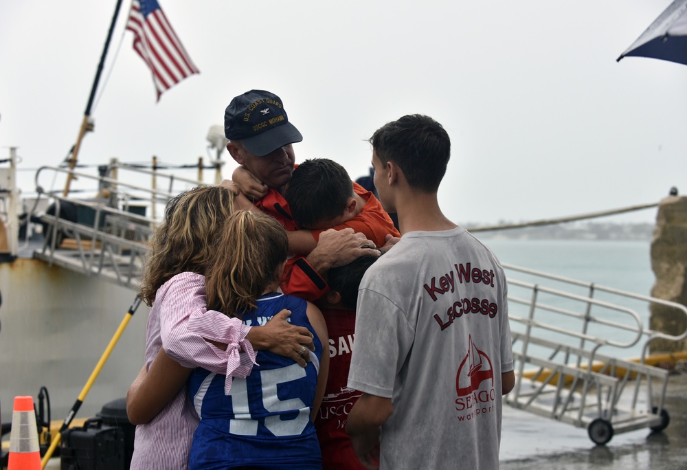 Commanding officer of the Coast Guard Cutter Mohawk greets his family following three-month patrol