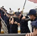 Coast Guard Cutter Mohawk crew members carry shore power cable onto pier following three-month patrol