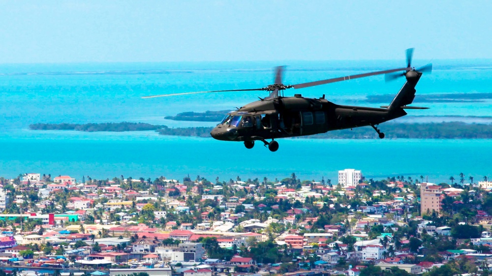 Black Hawk flies over Belize City