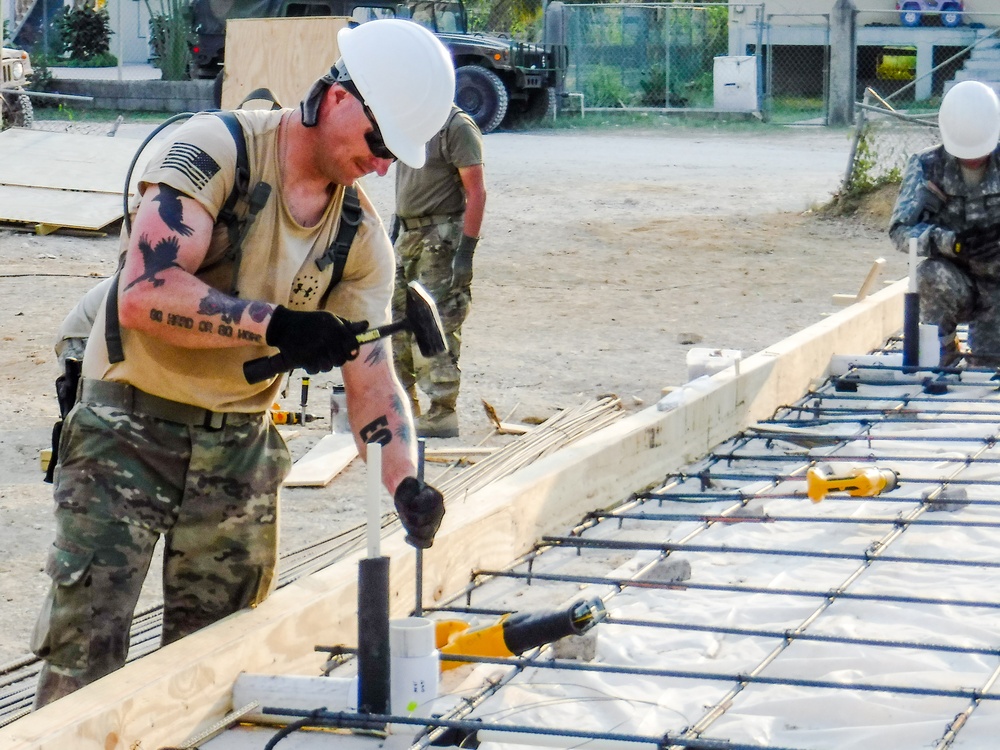 Sgt. Timothy Augustin drives a piece of rebar in a pre-drilled hole