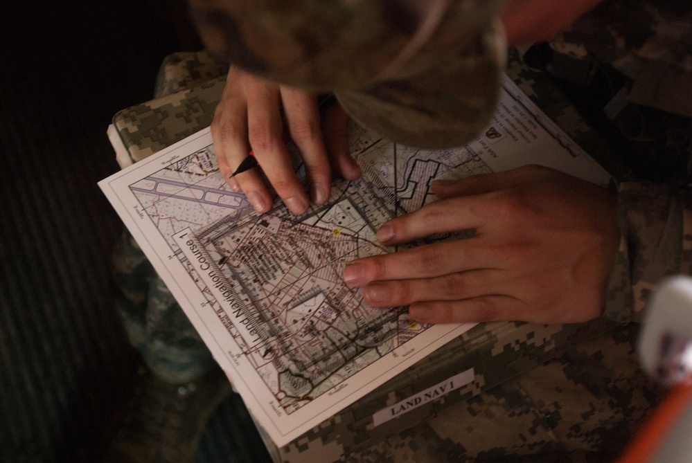 A soldier plots his navigation points on a base map