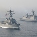 Two military warships are sailing in formation on open ocean waters under hazy atmospheric conditions. The foreground vessel is a US Navy Arleigh Burke-class guided-missile destroyer flying the American flag, bearing hull number 109. The background vessel is a Republic of Korea Navy destroyer flying the South Korean flag, indicating a joint naval exercise or patrol operation.