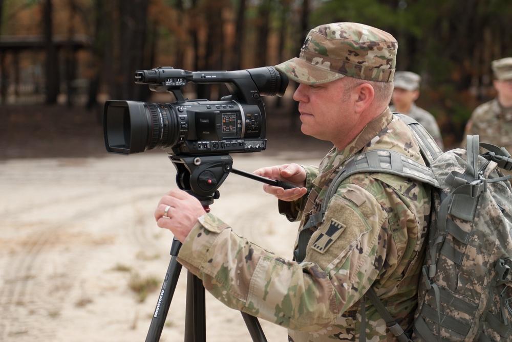 Staff Sgt. Jason Proseus films a M69 Training Hand Grenade throw