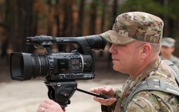 Staff Sgt. Jason Proseus films a M69 Training Hand Grenade throw