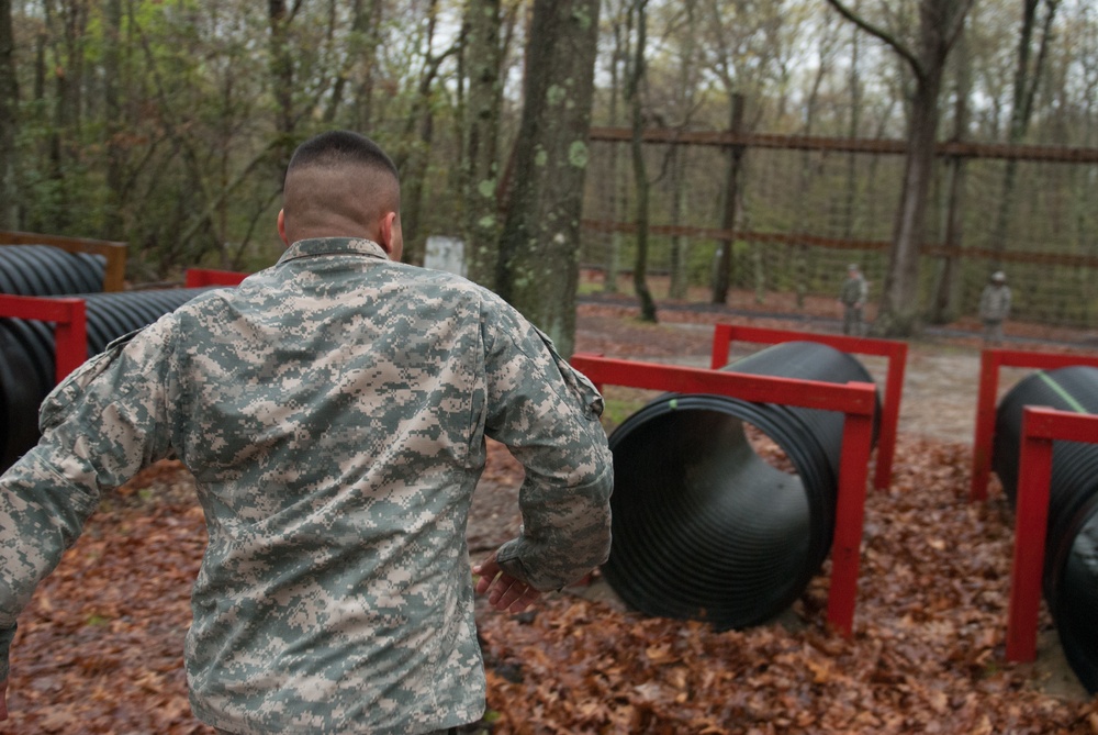 Sgt. Roberto Cruz prepares to enter a tunnel at the obstacle course