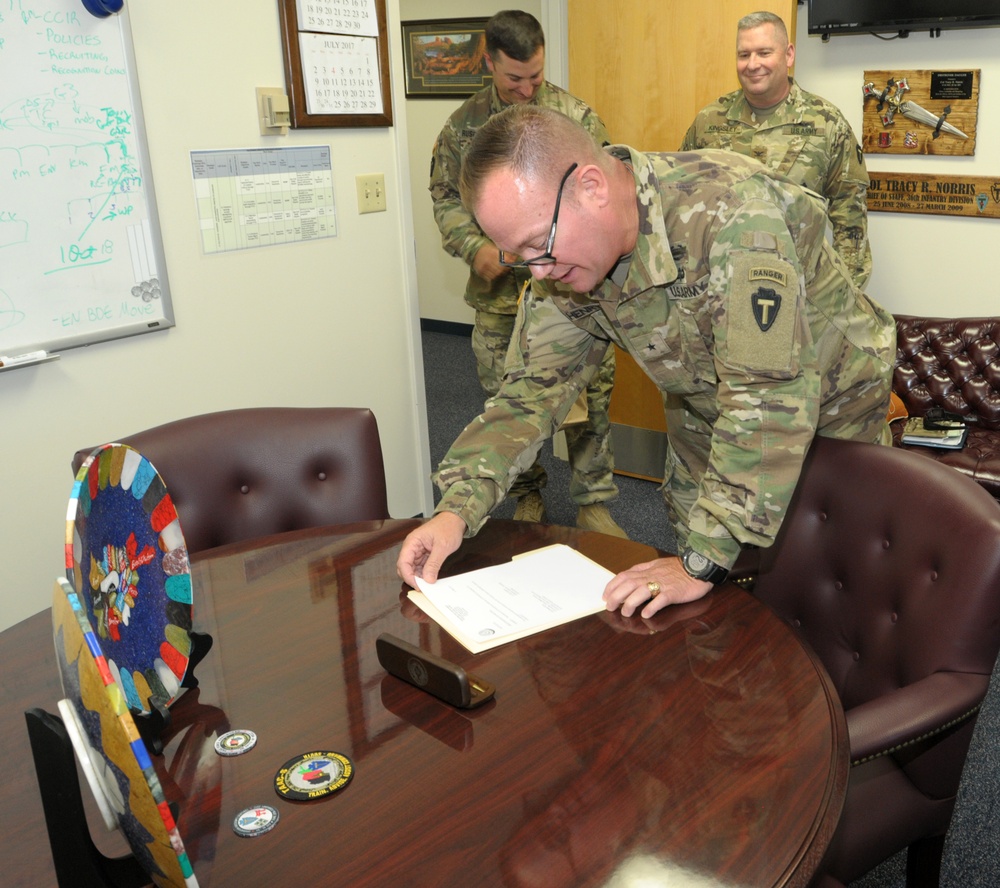 Brig. Gen. Lee Henry Signs Assumption of Command for 36th Infantry Division