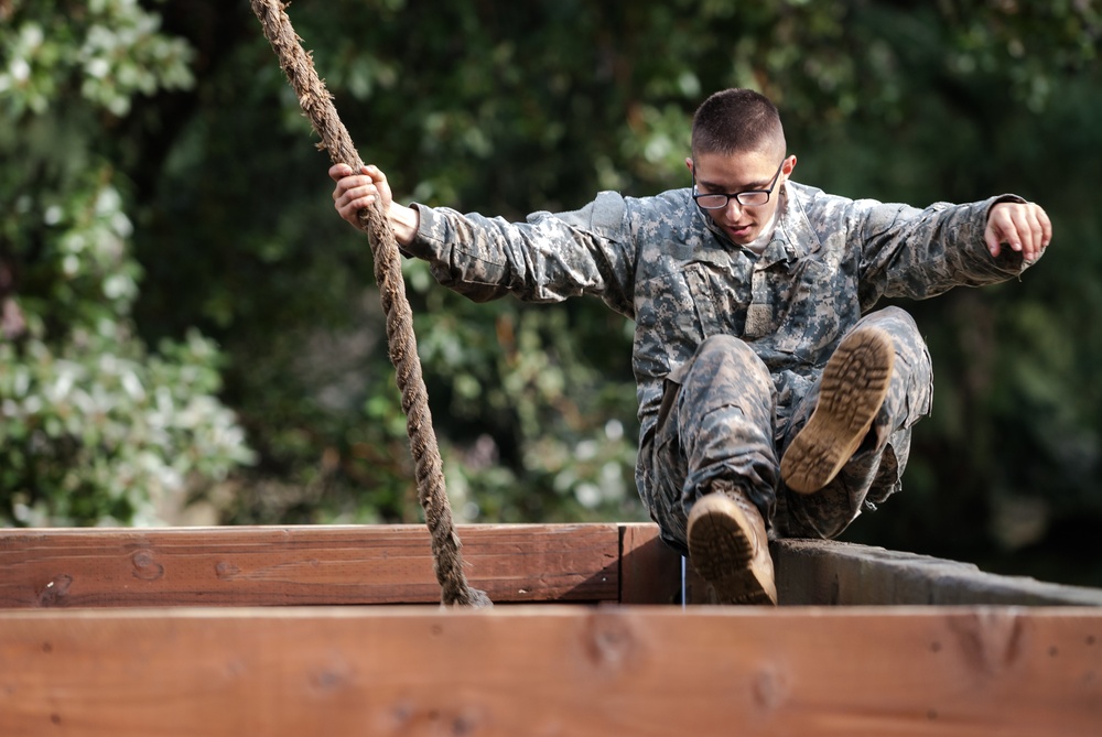 Pfc. Raymond A. Gomez leaps over an obstacle