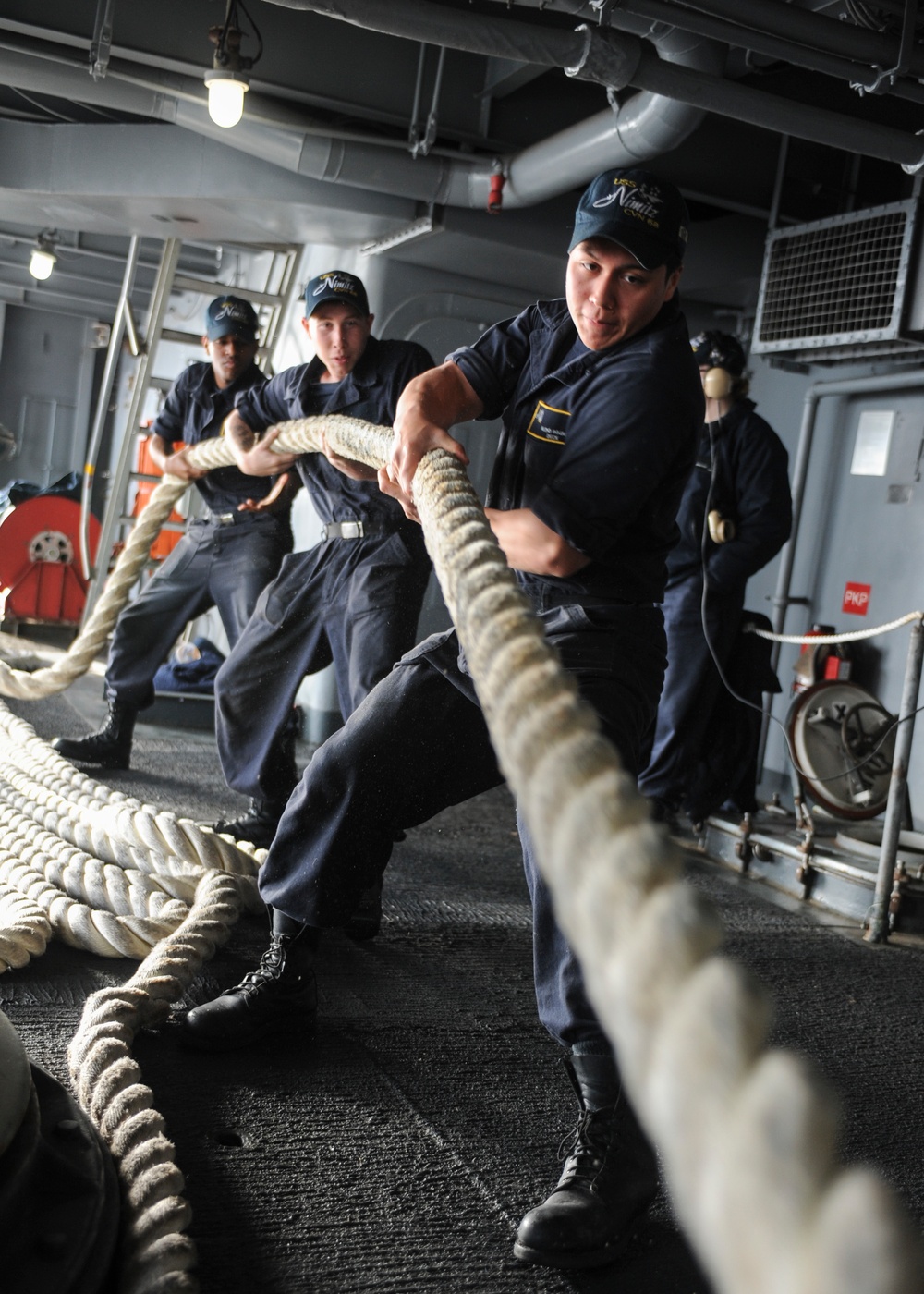 Sailors pull line in