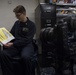 1st Class Cecil Chapman reads in the library of the Ticonderoga-class guided missile cruiser USS Leyte Gulf (CG 55) as part of the United Through Reading program