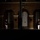 Marine Barracks Washington Evening Parade April 28, 2017 Two military personnel in formal dress uniforms stand at attention outside a brick building at night, illuminated by spotlights. The building features arched doorways and what appears to be an eagle emblem above the central entrance, consistent with a U.S. Marine Corps installation. The scene suggests a ceremonial guard duty or formal evening parade event.