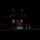 Marine Barracks Washington Evening Parade April 28, 2017 A nighttime military ceremony is taking place on a lawn in front of a large illuminated building. A color guard unit in dress uniforms is spotlit at center, carrying the American flag and what appears to be a Marine Corps flag. Spectators and additional uniformed personnel line the left side of the frame.