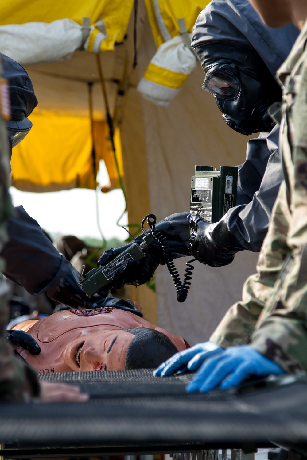 CBRN Soldier Checks Scenario Victim For Contamination