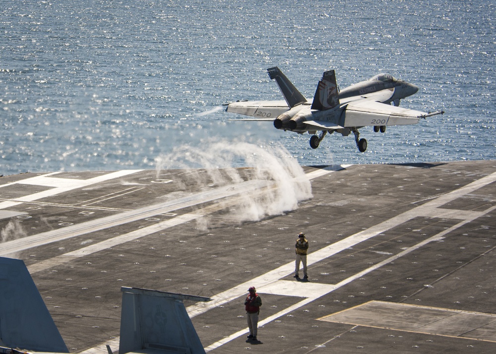 An F/A-18E Super Hornet from the “Kestrels” of Strike Fighter Squadron (VFA) 137 launches from the Nimitz-class aircraft carrier USS Carl Vinson (CVN 70)