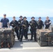 Coast Guard Cutter Dependable crew stands with interdicted narcotics