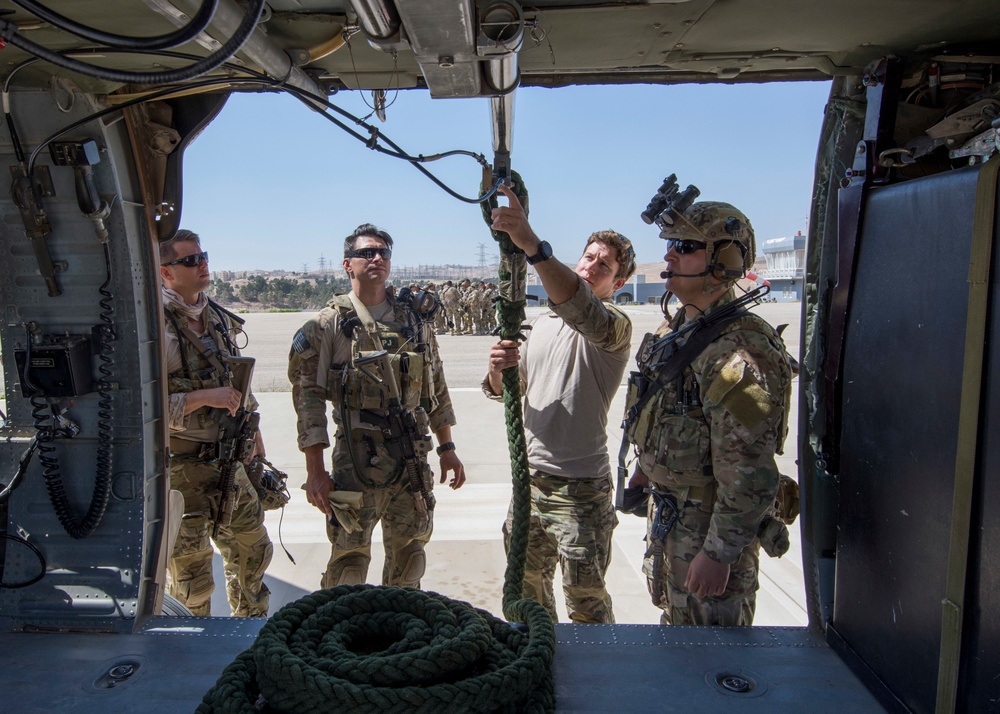 Members of the Air Force Special Operation's 23rd Special Tactics Squad inspect equipment prior to a fast roping exercise