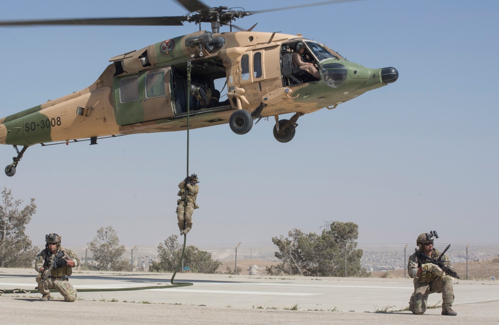 Members of the Air Force Special Operation's 23rd Special Tactics Squad secure a landing pad during a fast roping exercise in Amman, Jordan during Eager Lion 2017.