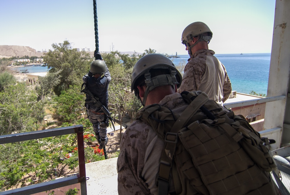 U.S. Marines watch a Jordanian Sailor fast rope during Eager Lion 17