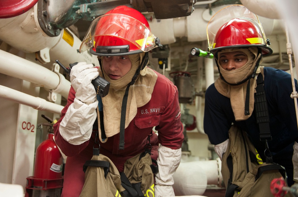 USS America Sailors investigate flooding during a damage control training team evolution