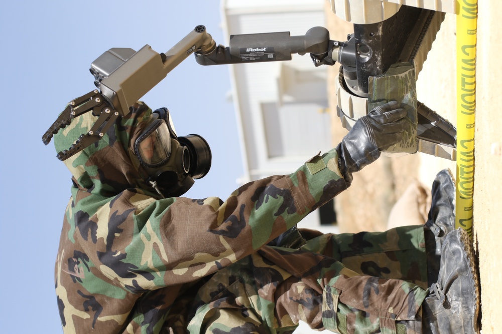 A Jordan Armed Forces soldier checks a recon robot for contamination during a CBRN scenario during Eager Lion 17