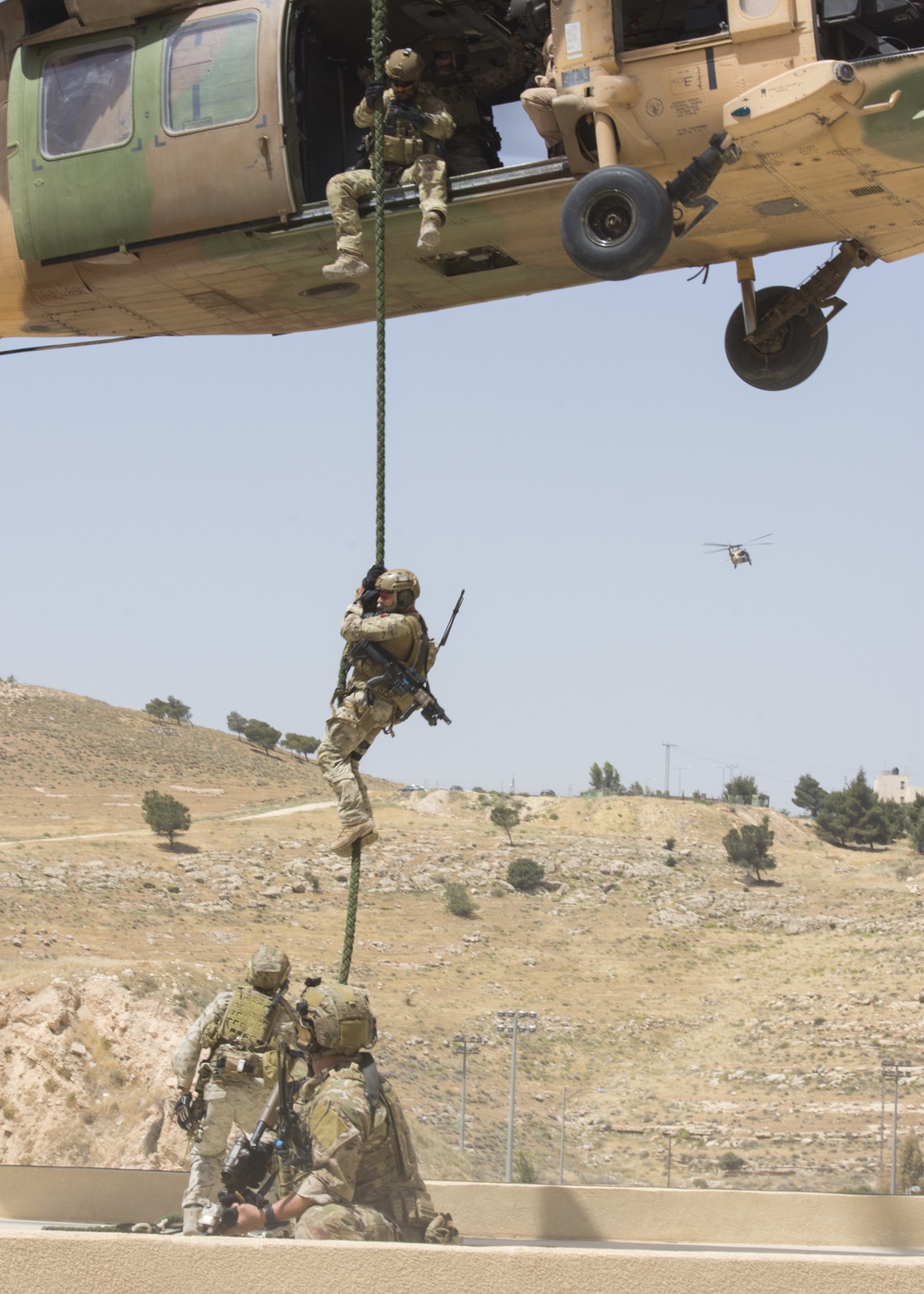 Members of the Air Force Special Operations from the 23rd Special Tactics Squadron fast rope from a Jordanian UH-60 helicopter during an exercise in support of Eager Lion 2017.