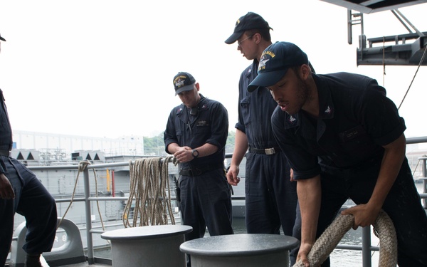 Seaman P.J. Buggs Loosens a Mooring Line From a Bitt