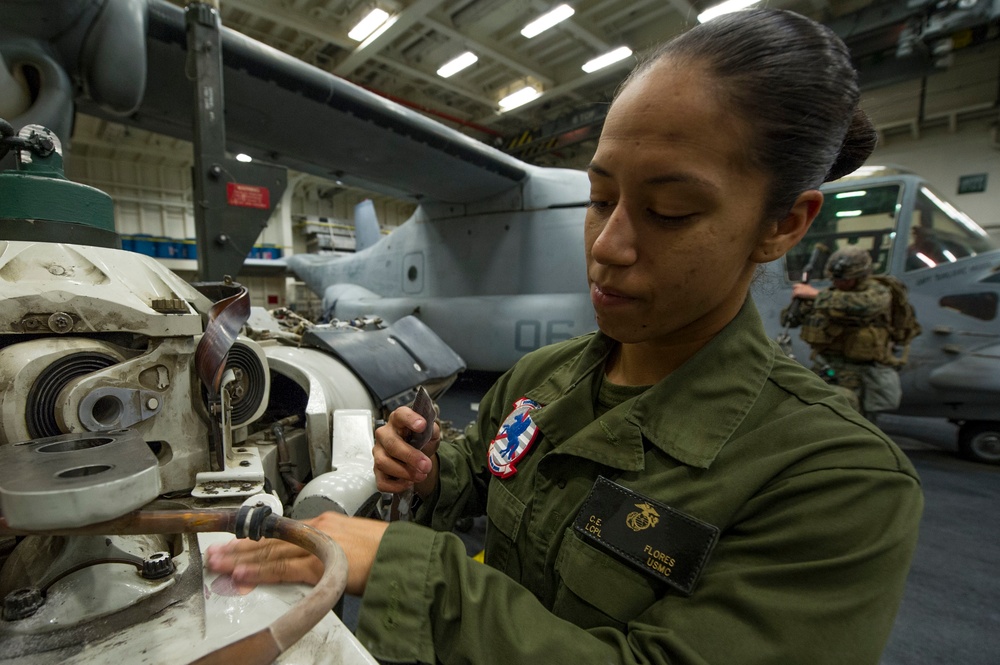 Marine on USS America conducts maintenance