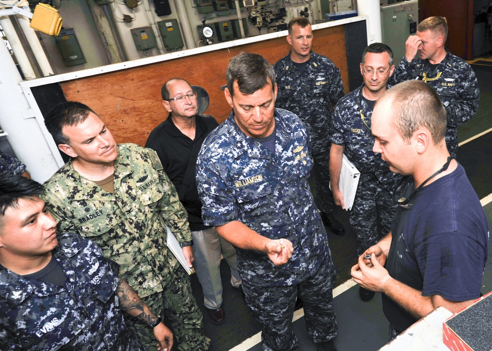 Rear Adm. Stephen Williamson toured USS Emory S. Land (AS 39) and other repair facilities in Guam to assess current operations and capabilities.