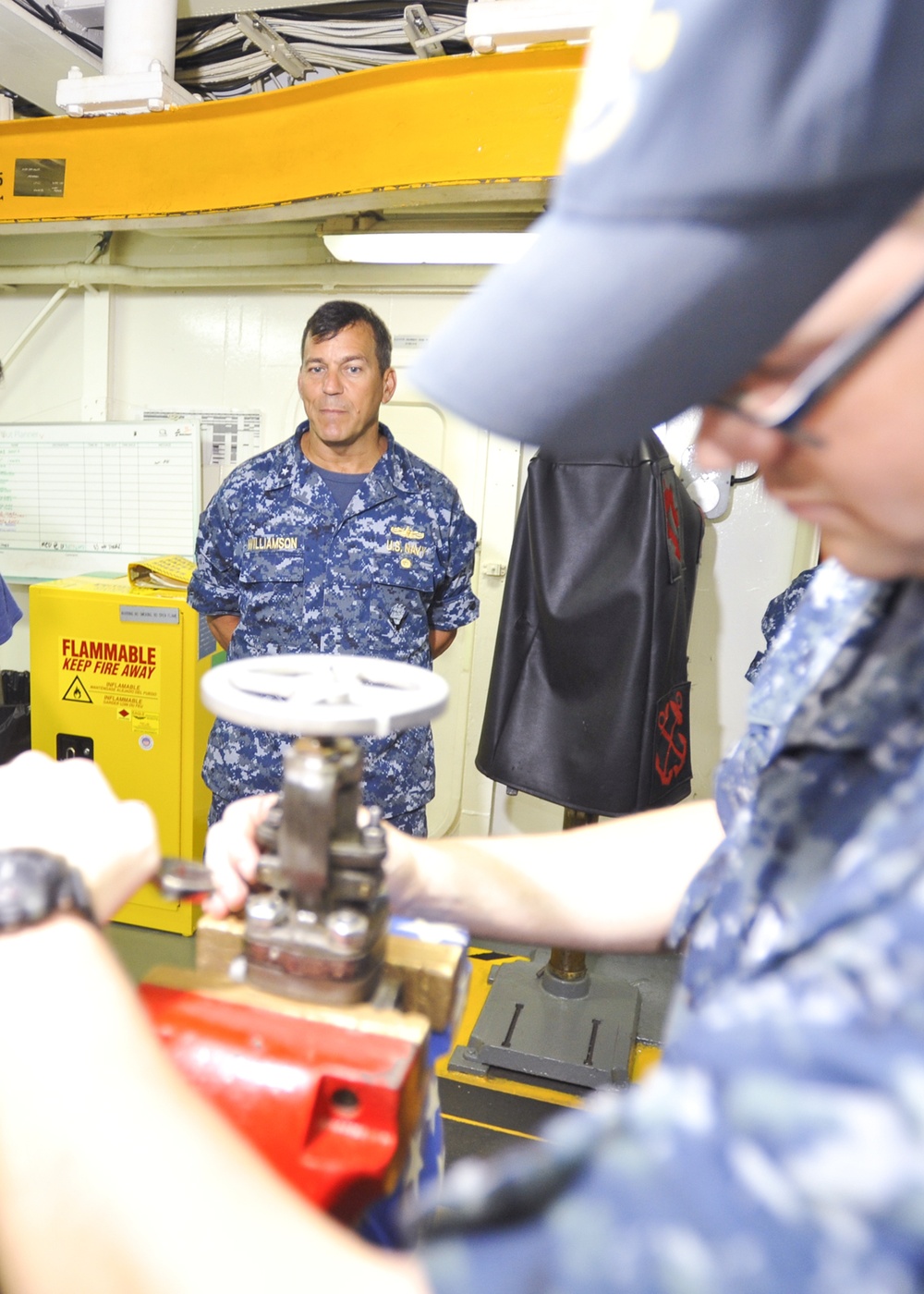 Rear Adm. Stephen Williamson toured USS Emory S. Land (AS 39) and other repair facilities in Guam to assess current operations and capabilities.