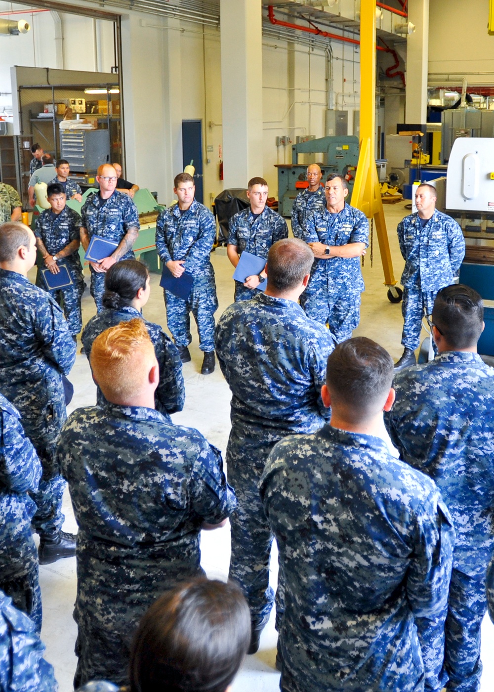 Rear Adm. Stephen Williamson toured USS Emory S. Land (AS 39) and other repair facilities in Guam to assess current operations and capabilities.