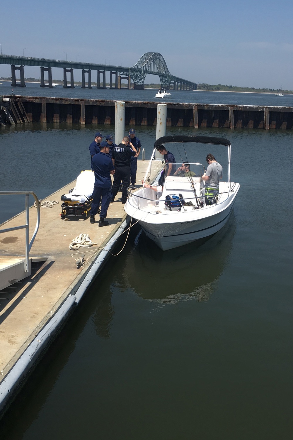 Coast Guard crewmembers administer first aid to 50-year-old boater at Fire Island