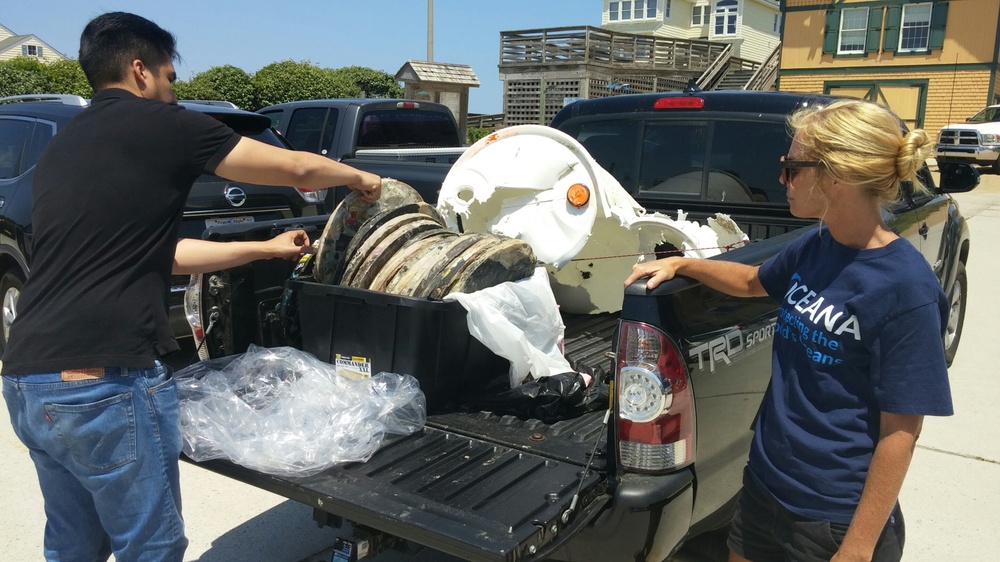 Navy representatives retrieve compressed plastic disks