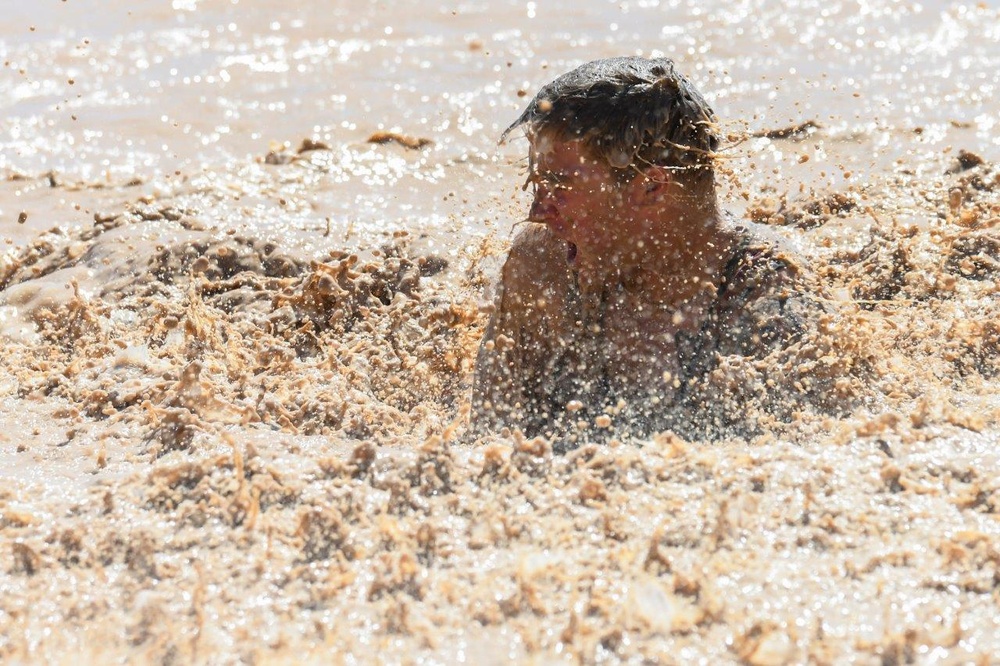 Old Ironsides Mud Challenge Soldiers, friends and family dive in