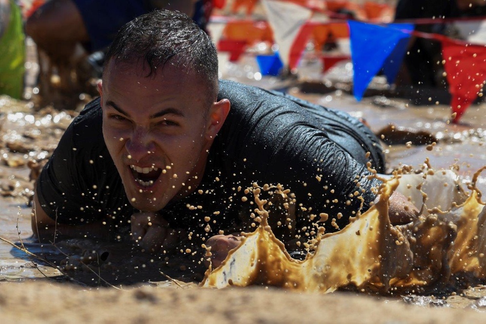 Old Ironsides Mud Challenge Soldiers, friends and family dive in