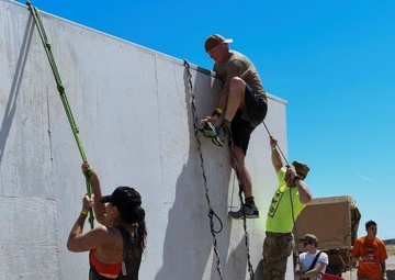 Old Ironsides Mud Challenge Soldiers, friends and family dive in