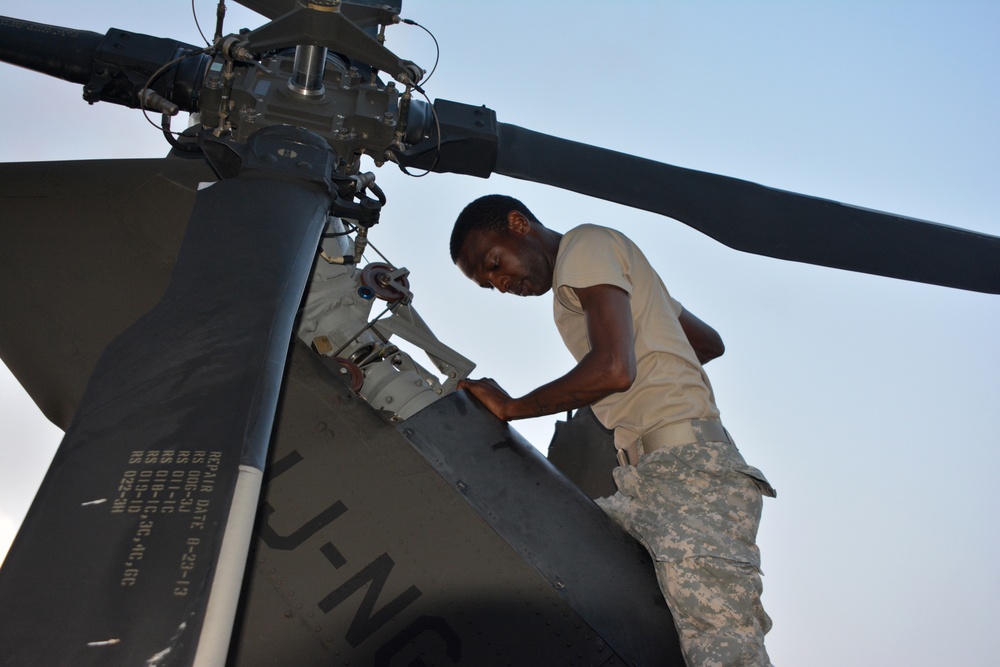 Soldier performs maintenance on the tail rotor of a UH-60 Black Hawk helicopter.