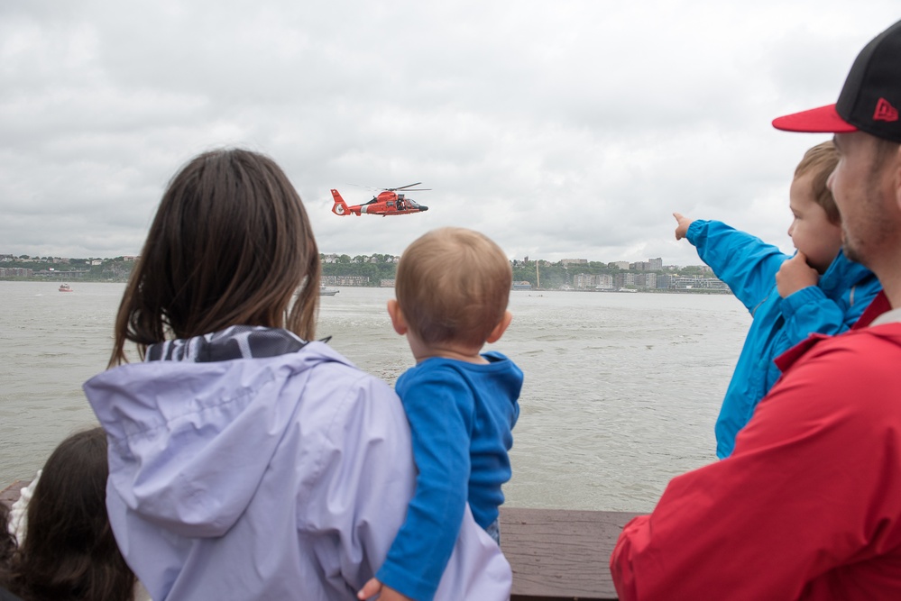 A family watches a helicopter search and rescue demonstration