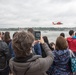 Crowd watches an HH-65 Dolphin crew from Air Station Atlantic City conduct a search and rescue demonstration