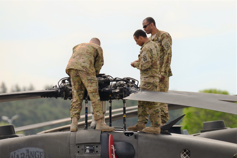 Soldiers working on Black Hawk rotor head.