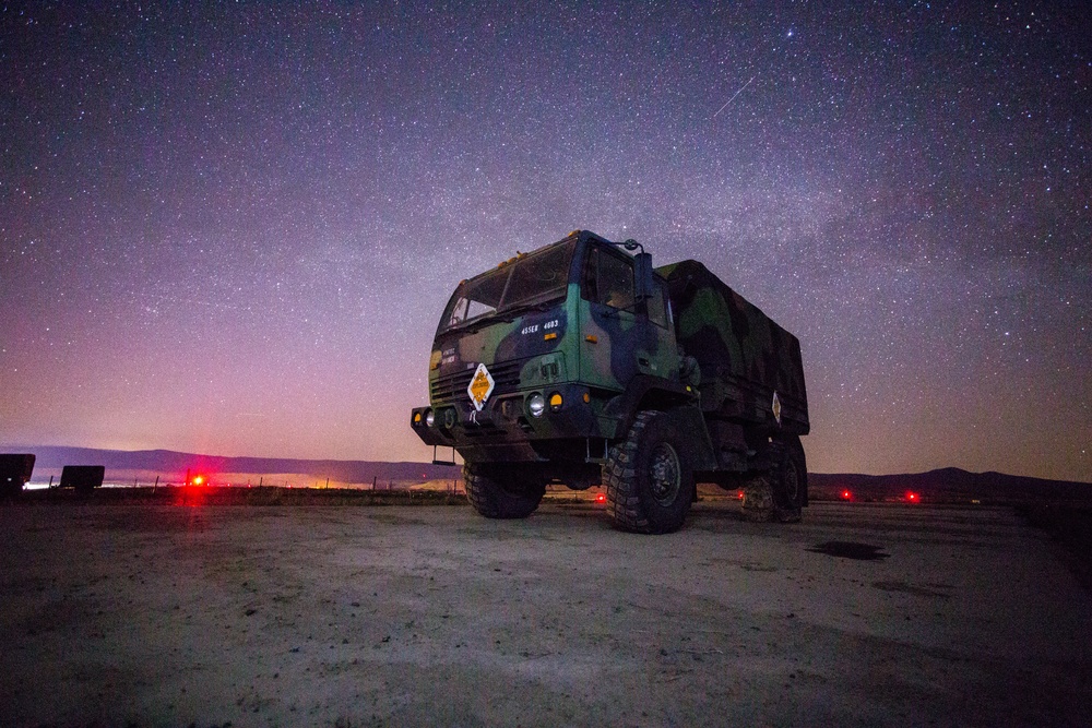 A LMTV stands watch during the night