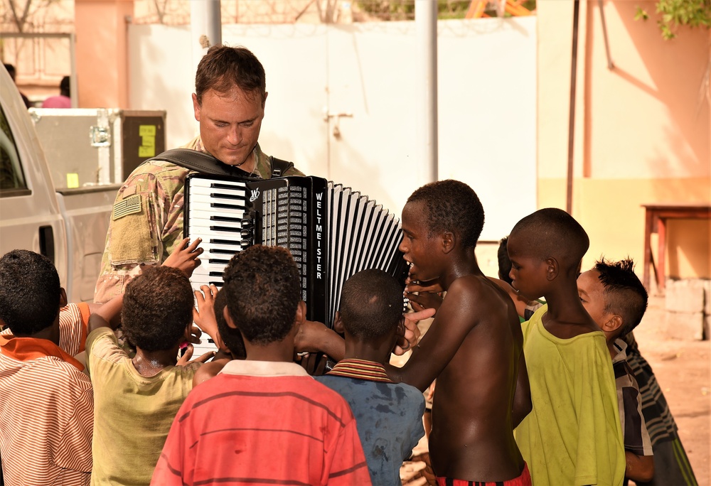 Caritas kids boogie, bond with AFCENT Band during Djibouti tour