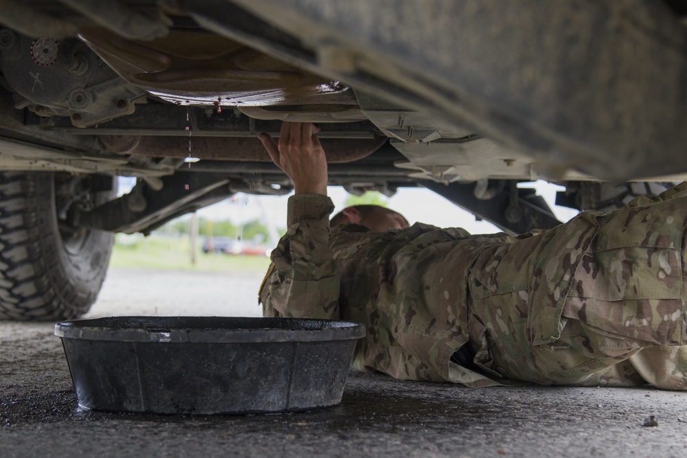 Soldier Works on Humvee Leak