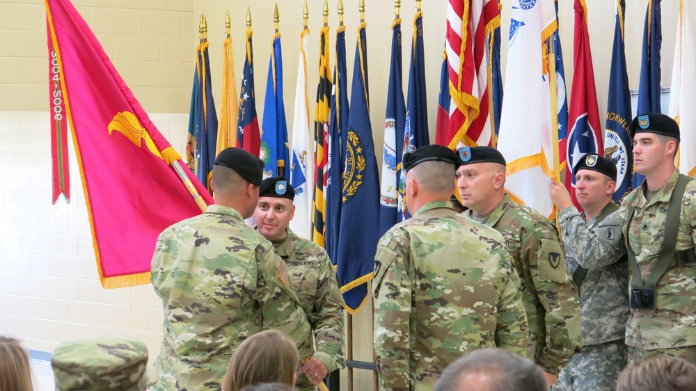 Lt. Col. Jeffrey Ignatowski, center, receives the Letterkenny Munitions Center colors from Col. James Hooper, left, during the Change of Command Ceremony, June 6. The outgoing commander is Lt. Col. Trenton Conner, right.