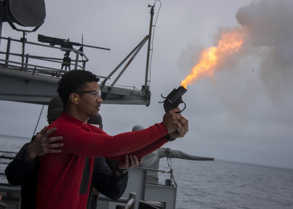 170605-N-LK571-833 WESTERN PACIFIC (June 5, 2017) Gunner’s Mate 2nd Class Deion Mahone, of Indianapolis, fires a flare gun during a live-fire exercise on the Nimitz-class aircraft carrier USS Carl Vinson (CVN 70) fantail. The U.S. Navy has patrolled the I